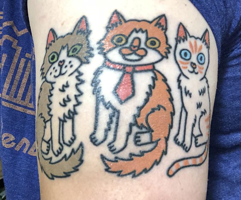 a tattoo of cartoon cats